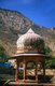 India: The walled fortifications of the Bala Qila (Alwar Fort) loom above a chhatri (pavilion) next to the Vinay Vilas (City Palace), Alwar, Rajasthan